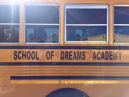 Side of School of Dreams Academy bus. 